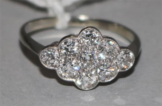 An 18ct gold, platinum and nine stone diamond cluster ring, size Q.